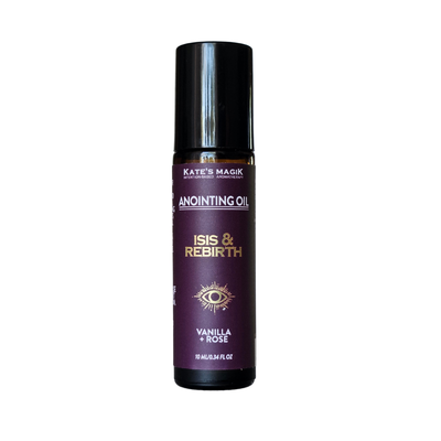 A bottle of Kate's Magick Anointing Oil, 'Isis & Rebirth' vanilla + rose scent, with a black cap and a dark purple label featuring gold text and an eye illustration, set against a plain white background.