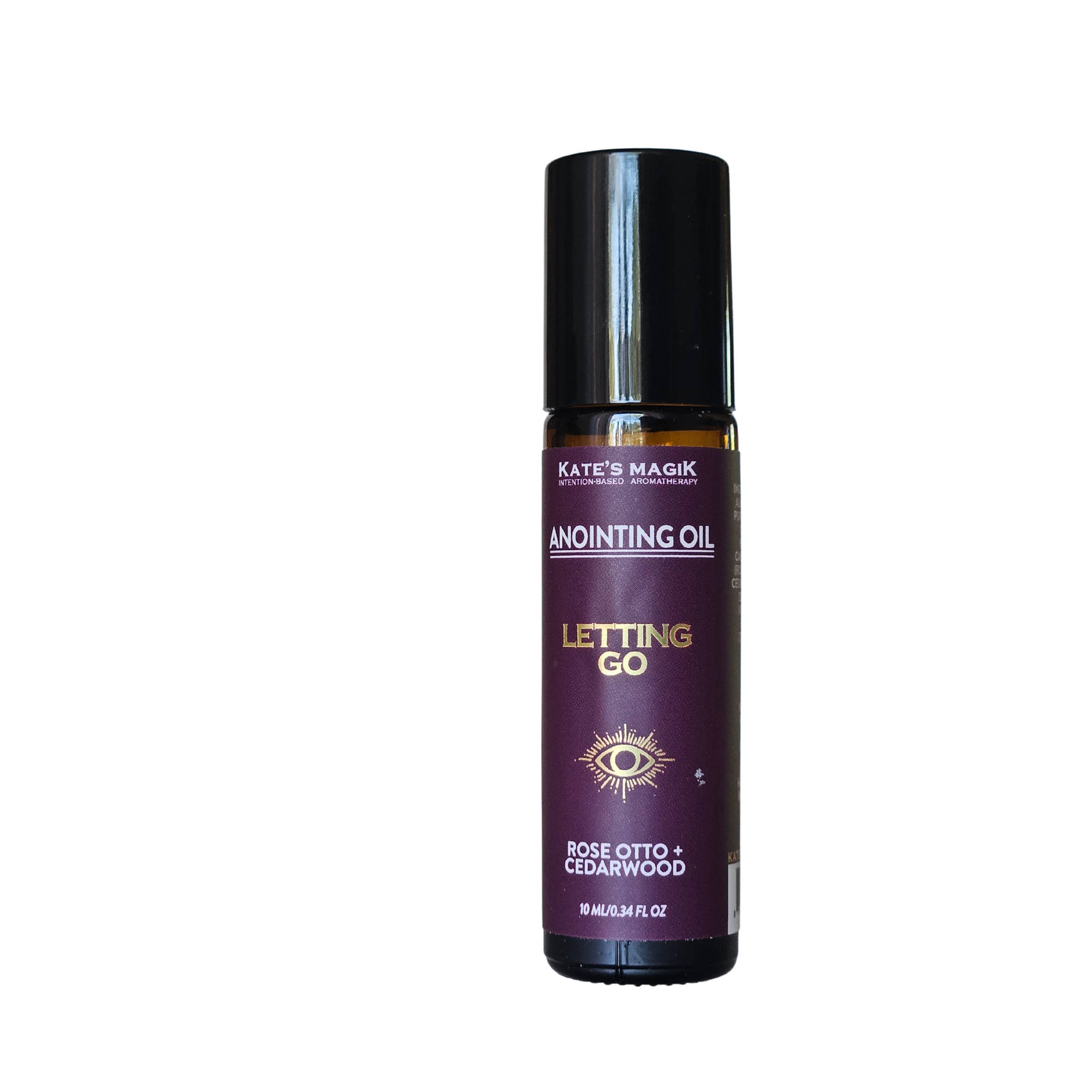 A bottle of Kate's Magick Anointing Oil, 'Letting Go' Rose Otto and Cedarwood scent, on a solid white background.