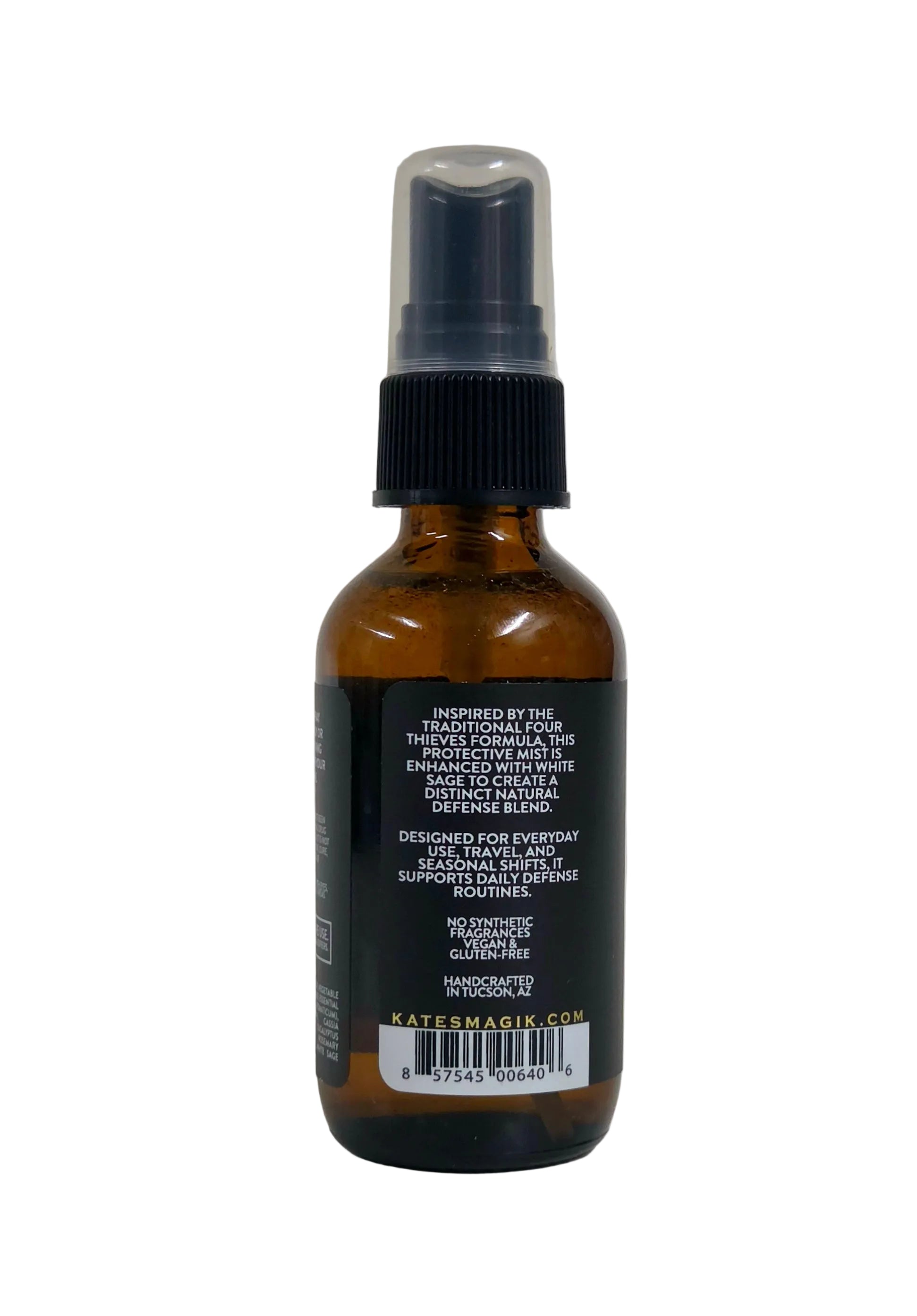 An amber glass spray bottle with a black spray top and a black label, photographed against a plain light background.