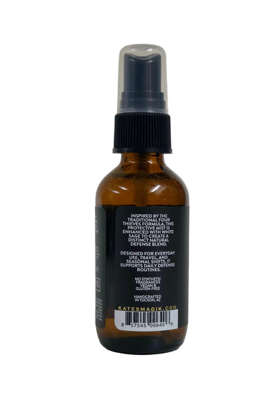 An amber glass spray bottle with a black spray top and a black label, photographed against a plain light background.