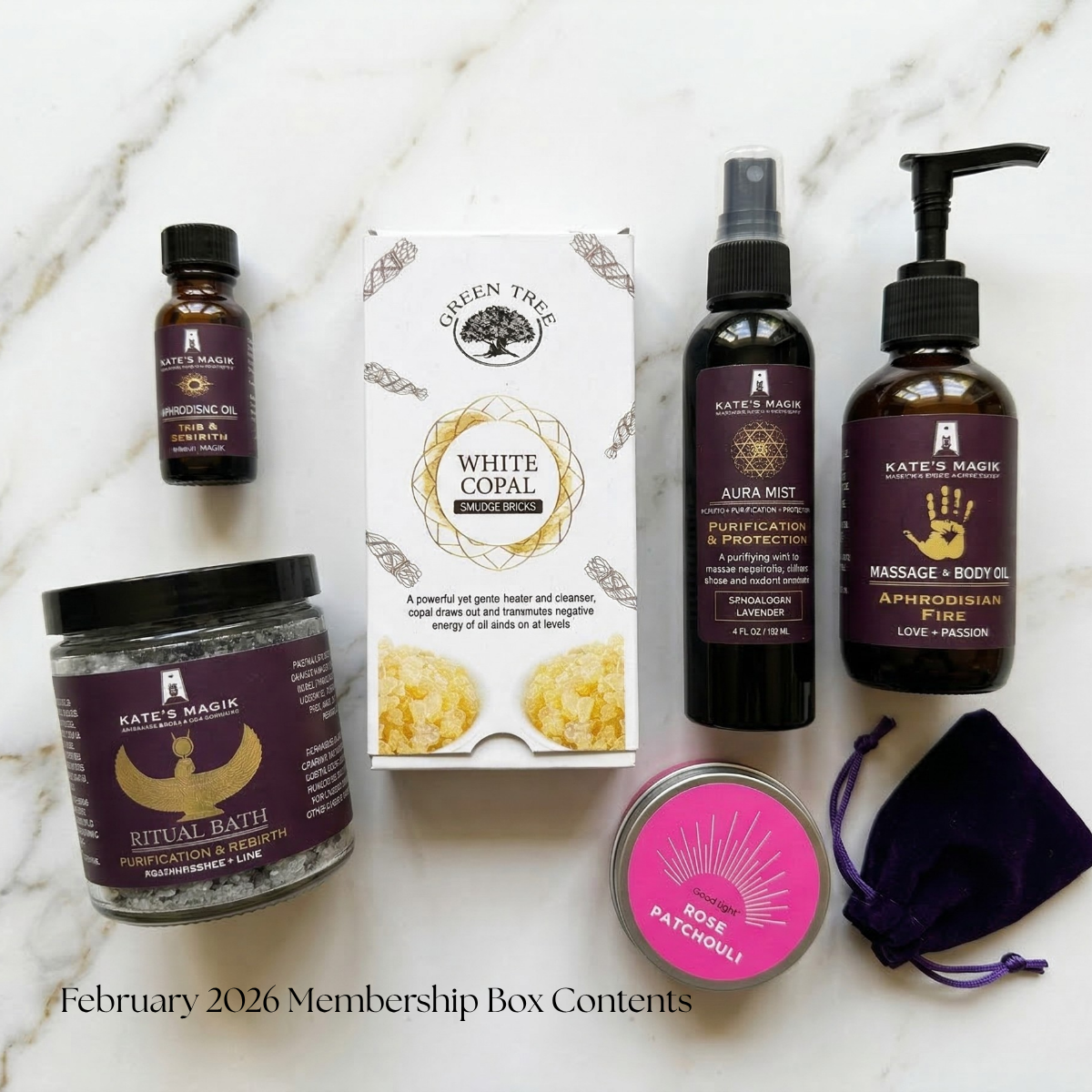 February 2026 Membership Box Contents from Kate's Magik, displayed on a white marble background. The set includes a White Copal incense box, a Ritual Bath salt jar, a bottle of Isis & Rebirth Anointing Oil, a Purification & Protection Aura Mist spray, an Aphrodisian Massage + Body Oil pump bottle, a pink 'Rose Patchouli' tinned candle, and a small purple velvet pouch.