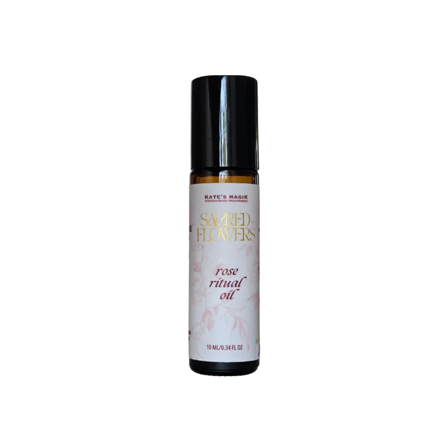 10ml amber glass roll-on bottle of Kate's Magik Sacred Flowers Rose Ritual Oil. White label with pale pink rose vines on the label, red lettering and gold Sacred Flowers name.