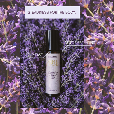 A bottle of Kate's Magik Lavender Ritual Oil centered against a background of purple lavender flowers, with text overlays reading 'STEADINESS FOR THE BODY.', 'DAILY EASE', and 'GENTLE GROUNDING'.