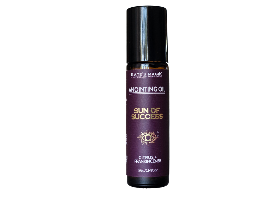 Sun of Success Anointing Oil from Kate's Magik, 10ml roll-on amber glass bottle with black cap on a white background, purple label with gold lettering